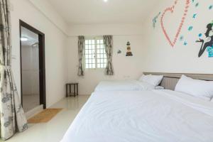Cama o camas de una habitación en 實在玩家民宿