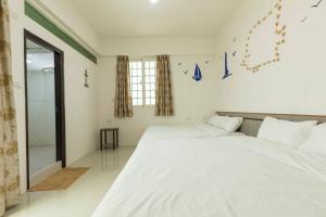Cama o camas de una habitación en 實在玩家民宿
