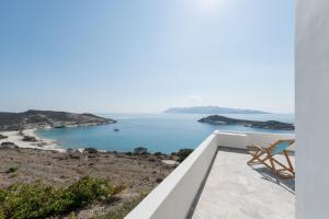 a white house with a view of the ocean at Kimolian Houses in Kimolos
