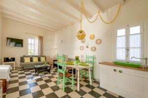 a kitchen and living room with a table and chairs at Kimolian Houses in Kimolos