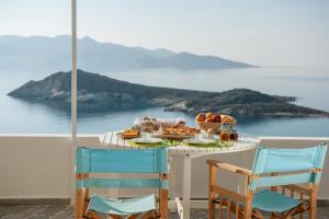 a table with food on it with a view of the ocean at Kimolian Houses in Kimolos +4 photos