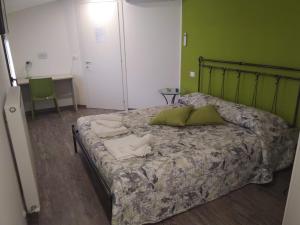 a bedroom with a bed with two pillows on it at B&B NONO TILIO in Talmassons