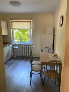 a kitchen and dining room with a table and chairs at Apartment on Karja in Narva-Jõesuu
