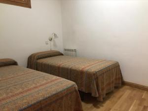 a hotel room with two beds in a room at Casa Oliván in Graus