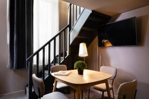 a room with a table and chairs and a staircase at Rayz Eiffel in Paris