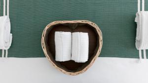 a basket filled with white towels on a table at Rivazzurra Homes - A in Termoli +240 photos