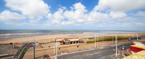 a view of a beach with a roller coaster at Queens Mansions: The Maisonette in Blackpool