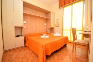 a room with a bed with two bows on it at Hotel Firenze in Bellaria-Igea Marina +49 photos