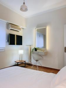 a bedroom with a bed and a sink and a mirror at API Projects Kolonaki - Casa Academia in Athens