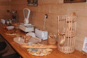 a counter with bread and baskets of loaves of bread at Hôtel Belalp in Châtel