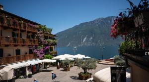 a group of buildings with a view of a lake at Garni Gianmartin in Limone sul Garda