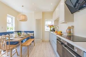 a kitchen with a table and a dining room at Boatman's Reading Rooms in Deal