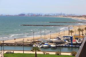 a group of boats docked at a beach at Sea You Apartamentos Valencia Port Saplaya in Port Saplaya