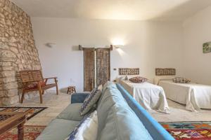 a living room with a couch and two beds at Villa Aurora in Torre Vado +60 photos