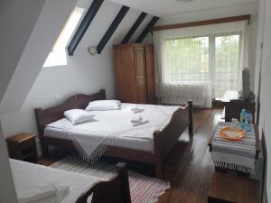 a bedroom with two beds and a window at Pensiunea Passiflora in Mănăstirea Humorului +18 photos