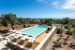a swimming pool with chaise lounge chairs and a swimming pool at Villa Aurora in Torre Vado