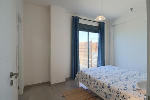 a bedroom with a bed and a bathroom with a window at ARCA DE BUEY LA RESERVA in El Rompido +19 photos