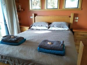 a bedroom with a bed with two towels on it at Pine Scrub Beach House in Lughrata