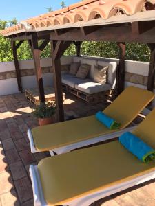 a gazebo with a couch and chairs under it at Serra & Mar Country Beach House in Alvor