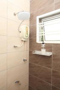 a shower in a bathroom next to a window at WARNI 45 Whole Or Room in Muar
