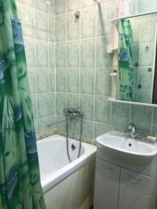 a bathroom with a sink and a bath tub and a sink at Апартаменты с прекрасным видом на море в Актау in Aktau +11 photos