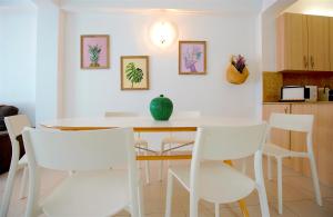 a dining room with a table and white chairs at La Lonja Homes - Turismo de interior in Palma de Mallorca +47 photos