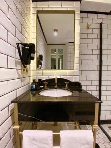 a bathroom with a sink and a mirror at A11 HOTEL Exclusive in Istanbul