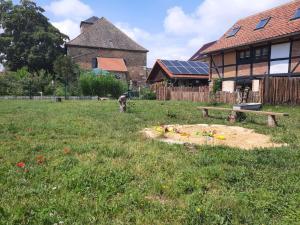 a yard with a sandbox in the grass next to a house at Villa Windschief in Thale