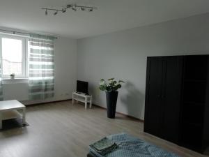 a living room with a black cabinet and a table at Apartmány Stdaniela in Bohumín