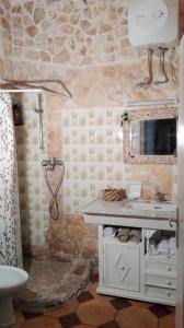 a bathroom with a white sink and a shower at Vista mare in Torre Lapillo