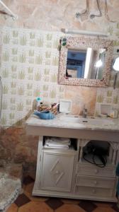 a bathroom with a sink and a mirror at Vista mare in Torre Lapillo +5 photos