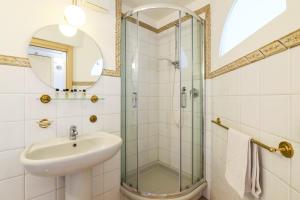 a bathroom with a sink and a shower at Duomo Cathedral View - Luxury Apartment in Milan