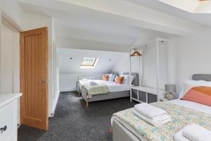 a bedroom with two beds and a closet at Listers Nest in Exley