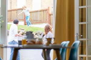 a man and two children playing at a table at Listers Nest in Exley