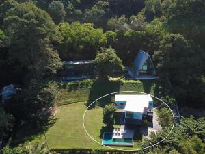 an aerial view of a house in the forest at Bamboo Garden House in Laem Sing