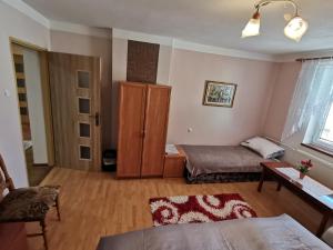 a living room with a bed and a cabinet at Privát pu Bartolomeja in Štrba