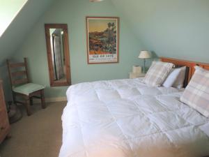 a bedroom with a large white bed and a chair at Northern Lights in Talmine