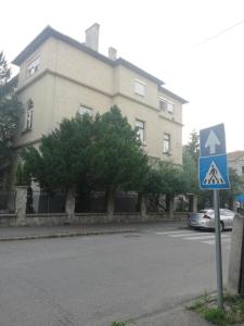 a street sign in front of a large building at GOLD 2 Apartman in Sopron