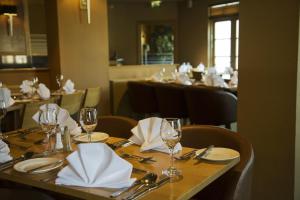 a table in a restaurant with glasses and napkins at Park Hotel in Falkirk