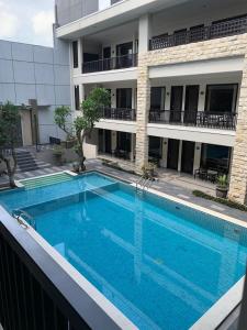 a large swimming pool in front of a building at Bintang Mulia Hotel & Resto in Jember
