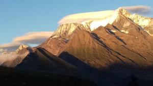 a view of a mountain with clouds in the background at Les Passereaux 2 in Saint-Gervais-les-Bains