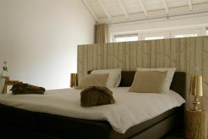 a bedroom with a large bed with two bags on it at Rosa Arvensis in Lottum +40 photos
