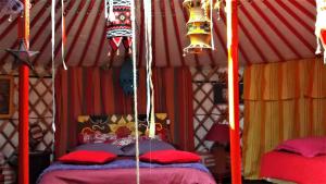 A bed or beds in a room at yourte-tipi-etretat