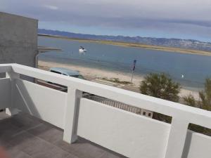 a balcony with a view of the beach and water at Apartman Mara in Vir