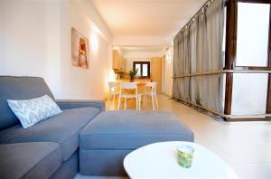 a living room with a blue couch and a table at La Lonja Homes - Turismo de interior in Palma de Mallorca