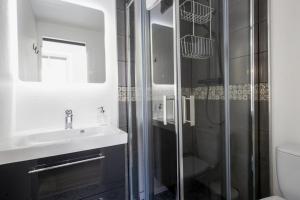 a bathroom with a sink and a shower at Studio Gaston - Welkeys in Biarritz