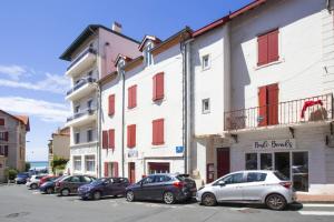 a row of cars parked in front of buildings at Studio Gaston - Welkeys in Biarritz