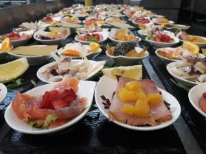 a table full of plates of different types of food at Hotel Mirasole International in Gaeta