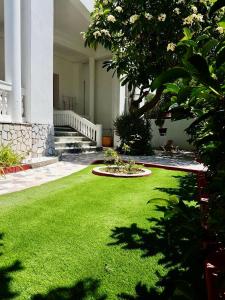 a yard of green grass in front of a building at The Metropolis Residence Rhodes in Rhodes Town