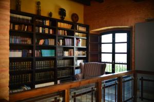 a room with bookshelves and a large window at Castillo de Monte la Reina Posada Rural & Bodega in Toro